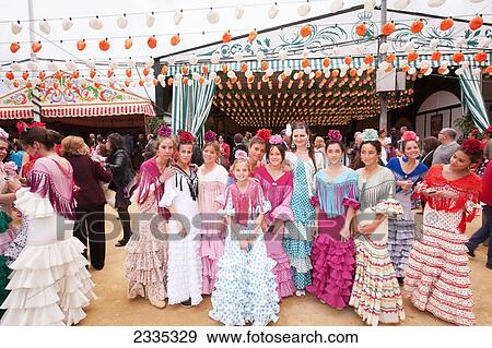 Group Of Young Women In Traditional Dresses During April Feria Festival; Seville, Andalucia, Spain View Large Photo Image Stock Photo - Group Of Young Women In Traditional Dresses During April Feria Festival; Seville, Andalucia, Spain. Fotosearch