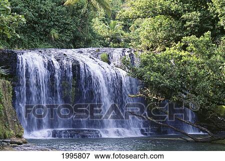 Stock Photo - Guam, Talofofo Falls, View Of Falls Spilling Into Pool, Surrounded By Trees. Fotosearch