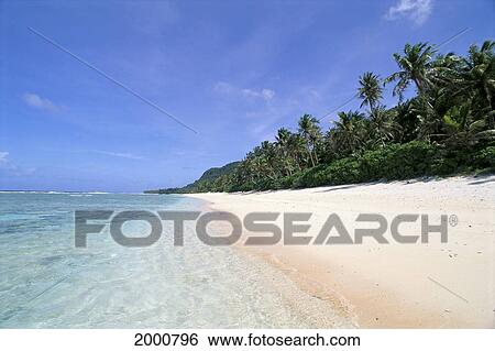Stock Photograph - Guam, Urunao Beach, Clear Water With Deserted Sands Palm Lined, Blue Sky. Fotosearch