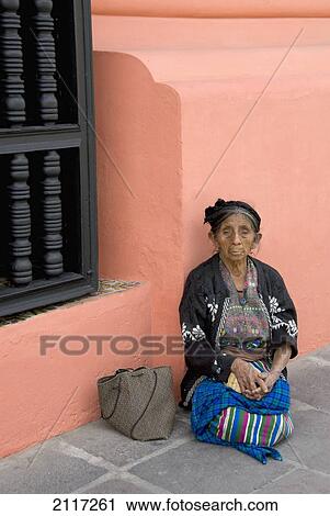 Stock Image - Guatemala, Antigua, indigenous woman dressed in traditional clothing. Fotosearch