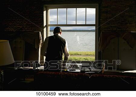 Stock Photo - Guest in a room at the Singular Hotel; Natales, Magallanes and Antartica Chilena Region, Chile. Fotosearch