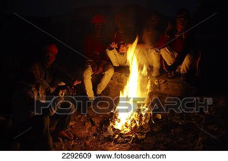 Guides sitting around camp fire at Castle Mandawa Hotel Mandawa Rajasthan India View Large Photo Image Stock Photo - Guides sitting around camp fire at Castle Mandawa Hotel Mandawa Rajasthan India. Fotosearch