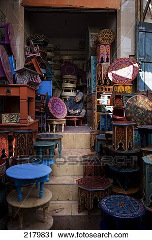 Stock Image - Hand painted tables in the souk; Marrakesh, Morocco. Fotosearch