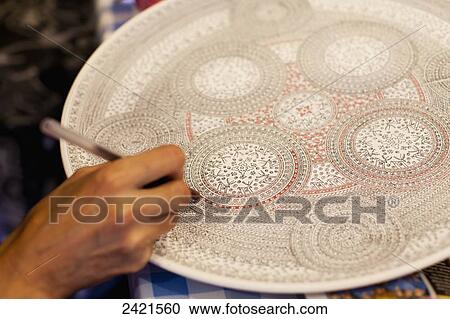 Stock Image - Hand painting a decorative plate; Avanos, Cappadocia, Turkey. Fotosearch