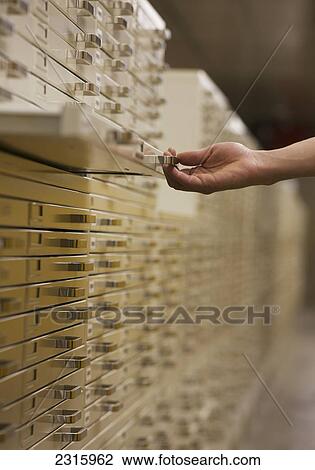 Stock Image - Hand Pulling Out Filing Drawer; Ottawa Ontario Canada. Fotosearch