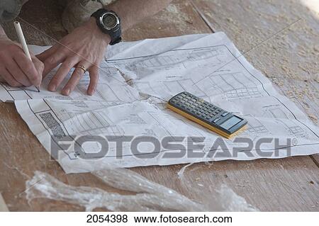 Hands Of Contractor Writing Down Measurements On Set Of Blueprints, Ontario View Large Photo Image Stock Photo - Hands Of Contractor Writing Down Measurements On Set Of Blueprints, Ontario. Fotosearch