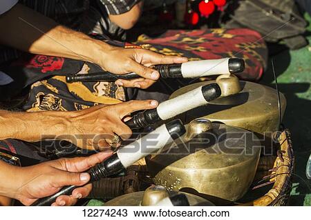 Hands of gamelan musicians playing bonangs during a Ngaben or Cremation Ceremony, Klungkung, Bali, Indonesia View Large Photo Image Stock Image - Hands of gamelan musicians playing bonangs during a Ngaben or Cremation Ceremony, Klungkung, Bali, Indonesia. Fotosearch