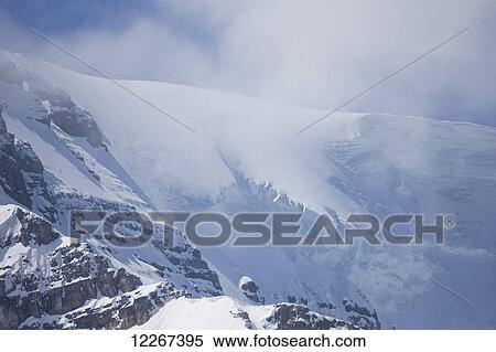Stock Photography - Hanging glacier off of the Columbia Icefield in the Canadian Rockies and is located in both Jasper and Banff National Parks; Alberta, Canada. Fotosearch