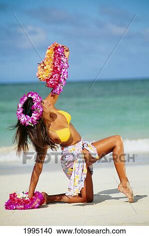 Stock Image - Hapa Woman Kneeling On Beach Holding Leis.. Fotosearch