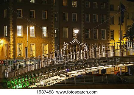 Stock Photo - Ha'penny Bridge Over Liffey River At Night; Dublin County Dublin Ireland. Fotosearch