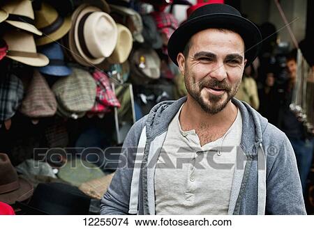 Picture - Hat salesman, Portobello Road Market; London, England. Fotosearch