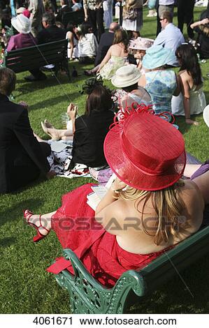 Stock Image - Hats and fashionable clothes at new Grandstand Enclosure during Royal Ascot horse racing meeting; Berkshire, England. Fotosearch