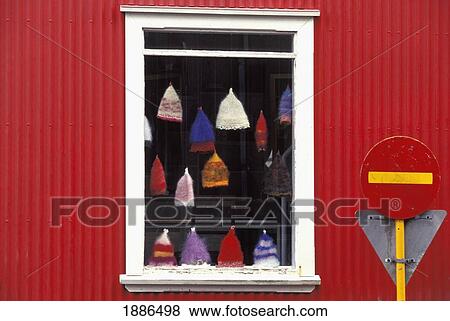 Stock Photo - Hats Hanging In Shop Window Of Red Building, Close Up. Fotosearch