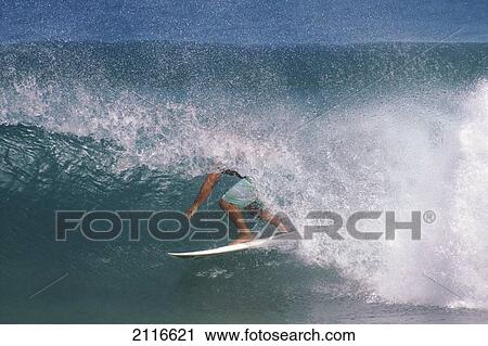 Stock Image - Hawaii, A surfer under a wave tube.. Fotosearch