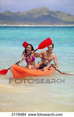 Hawaii, A young couple paddling their kayak. View Large Photo Image Picture - Hawaii, A young couple paddling their kayak.. Fotosearch