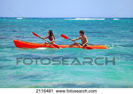 Hawaii, A young couple paddling their kayak. View Large Photo Image Stock Image - Hawaii, A young couple paddling their kayak.. Fotosearch
