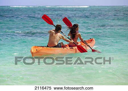 Hawaii, A young couple paddling their kayak. View Large Photo Image Stock Photography - Hawaii, A young couple paddling their kayak.. Fotosearch