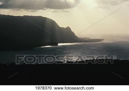 Stock Image - Hawaii, Bali Hai At Sunset, Sun Coming Through The Clouds.. Fotosearch