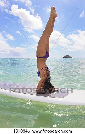 Hawaii, Beautiful Brunette Girl Doing A Headstand On Her Stand Up Paddle Board View Large Photo Image Stock Photography - Hawaii, Beautiful Brunette Girl Doing A Headstand On Her Stand Up Paddle Board. Fotosearch