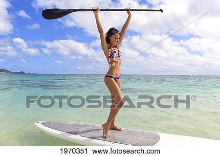 Stock Image - Hawaii, Beautiful Brunette Girl In Bikini On Her Stand Up Paddle Board. Fotosearch
