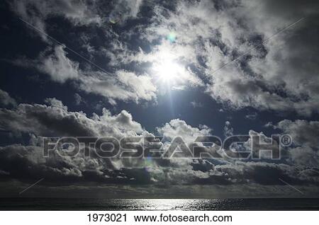 Stock Image - Hawaii, Beautiful Clouds With The Burst Of Sun.. Fotosearch