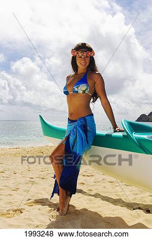 Hawaii, Beautiful Hawaiian Girl Wearing Blue Pareo And Haku, Leaning Against The Front Of An Outrigger Canoe On The Beach View Large Photo Image Stock Photo - Hawaii, Beautiful Hawaiian Girl Wearing Blue Pareo And Haku, Leaning Against The Front Of An Outrigger Canoe On The Beach. Fotosearch