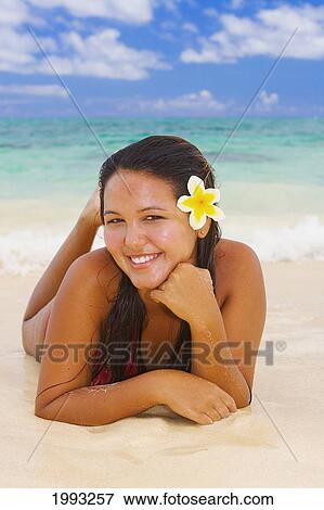 Stock Photo - Hawaii, Beautiful Hawaiian Girl With Plumeria Laying On Tropical Beach. Fotosearch