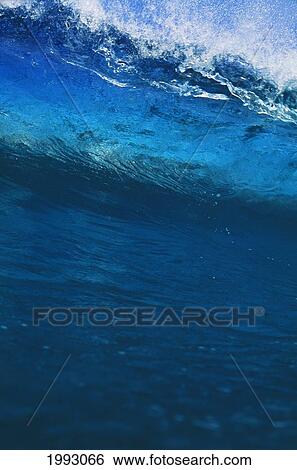 Stock Photograph - Hawaii, Big Blue Wave Begins To Crash.. Fotosearch