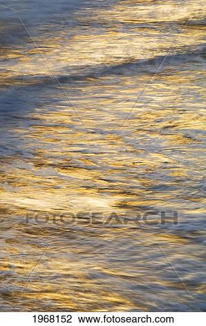 Stock Image - Hawaii, Big Island, Abstract View Of Colorful Reflections On Calm Water.. Fotosearch