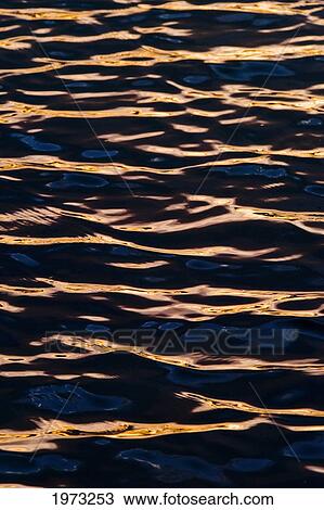 Stock Image - Hawaii, Big Island, Abstract View Of Colorful Reflections On Calm Water.. Fotosearch