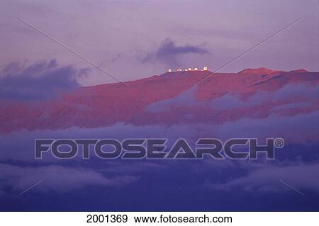 Stock Photo - Hawaii, Big Island, Distant View Mauna Kea Observatories At Summit, Twilight Clouds Foreground Soft Light. Fotosearch