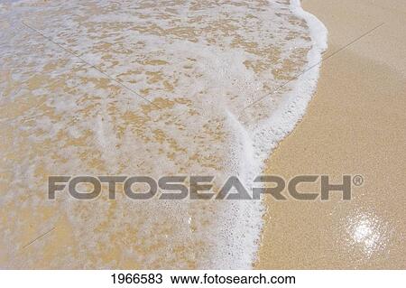 Stock Image - Hawaii, Big Island, Hapuna Beach, Sea Foam On Sandy Shore.. Fotosearch