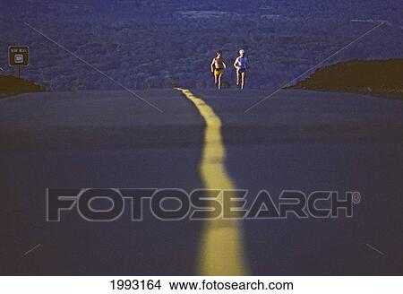 Picture - Hawaii, Big Island, Hawaii Volcanoes National Park, Long Distance Runners Along Chain Of Craters Road, South West Riff. Fotosearch