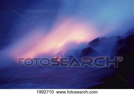 Stock Image - Hawaii, Big Island, Hawaii Volcanoes National Park, Lava Flows Into Ocean At Twilight, Creating A Purple Mist.. Fotosearch