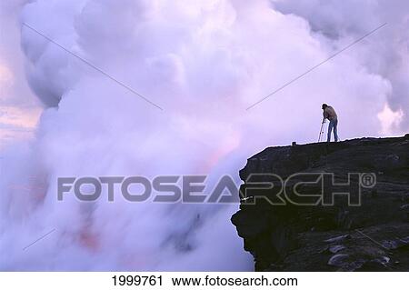 Stock Image - Hawaii, Big Island, Hawaii Volcanoes National Park, Photographer Takes Pictures Of Molten Lava, Steam. Fotosearch