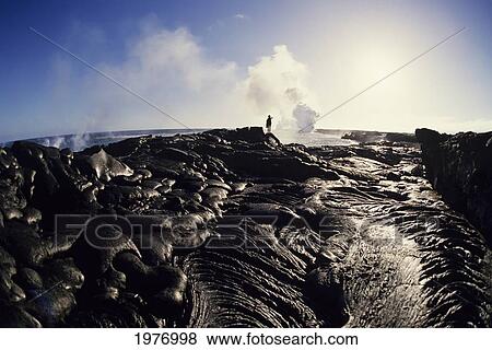 Hawaii, Big Island, Hawaii Volcanoes National Park, East Rift Zone, Person Observing Lava Flow Into Ocean In Distance. View Large Photo Image Stock Photo - Hawaii, Big Island, Hawaii Volcanoes National Park, East Rift Zone, Person Observing Lava Flow Into Ocean In Distance.. Fotosearch