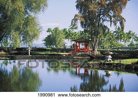 Stock Image - Hawaii, Big Island, Hilo, Liliuokalani Gardens. Red Pagoda Bridge Over Water.. Fotosearch