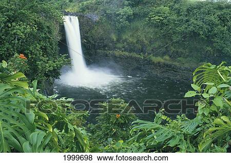 Stock Photo - Hawaii, Big Island, Hilo, Rainbow Falls View From Distance Surrounded By Tropical Foliage. Fotosearch