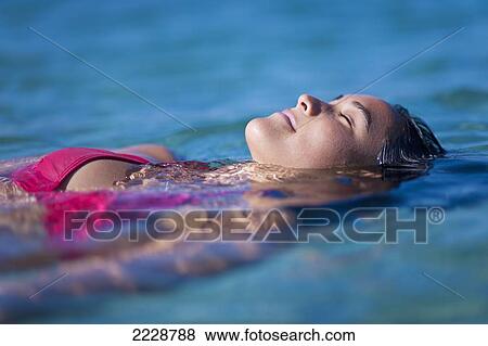 Hawaii, Big Island, Honaunau Bay, Beautiful Youn Woman Floating At Oceans Surface. View Large Photo Image Stock Photo - Hawaii, Big Island, Honaunau Bay, Beautiful Youn Woman Floating At Oceans Surface.. Fotosearch