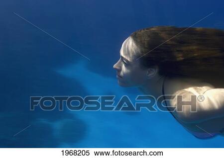 Stock Photography - Hawaii, Big Island, Honaunau Bay, Young Woman Swims Underwater.. Fotosearch