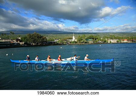 Stock Image - Hawaii, Big Island, Kailua-Kona Town, Six Man Canoe Paddling Along Coastline Near Ali'i Drive.. Fotosearch
