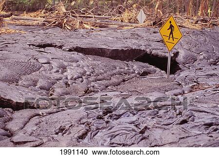 Stock Image - Hawaii, Big Island, Kalapana, Harry K. Brown Park, Pedestrian Crossing Sign Covered By Lava. Fotosearch