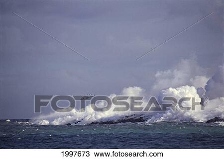Stock Image - Hawaii, Big Island, Kalapana Lava Flowing Into Ocean At Kaimu Black Sands Beach, Helicopter Fly Over, Clouds Of Smoke A27E. Fotosearch