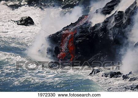 Stock Image - Hawaii, Big Island, Kalapana, Pahoehoe Lava Flowing From Kilauea Reaching The Pacific Ocean.. Fotosearch