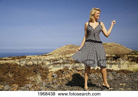 Hawaii, Big Island, Kohala Coast, Woman In A Beautiful Dress Dancing In A Desolate Field. View Large Photo Image Stock Photo - Hawaii, Big Island, Kohala Coast, Woman In A Beautiful Dress Dancing In A Desolate Field.. Fotosearch