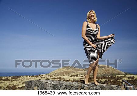 Hawaii, Big Island, Kohala Coast, Woman In A Beautiful Dress Dancing In A Desolate Field. View Large Photo Image Stock Photo - Hawaii, Big Island, Kohala Coast, Woman In A Beautiful Dress Dancing In A Desolate Field.. Fotosearch