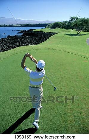 Hawaii, Big Island, Kohala, Mauna Lani Golf Course, 7Th Tee, Honokaape Tee Off, View From Behind Man Swinging A18A. Editorial Use Only. View Large Photo Image Stock Photo - Hawaii, Big Island, Kohala, Mauna Lani Golf Course, 7Th Tee, Honokaape Tee Off, View From Behind Man Swinging A18A. Editorial Use Only.. Fotosearch