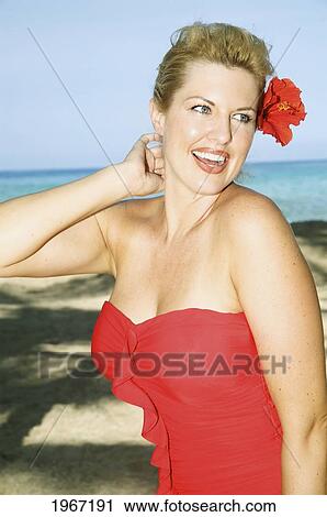 Stock Image - Hawaii, Big Island, Kona, Beautiful Woman On Beach Wearing Red Swimsuit.. Fotosearch