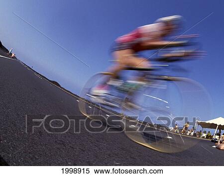Stock Photography - Hawaii, Big Island, Kona, Blurred Cyclist On Highway, Ironman Triathlon. Fotosearch