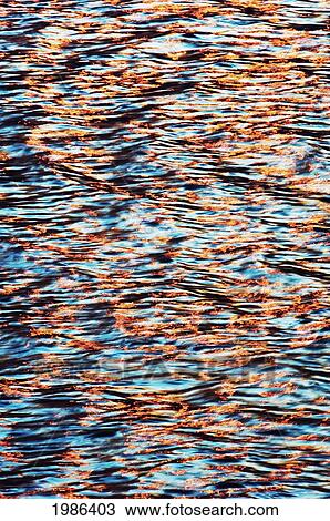 Stock Image - Hawaii, Big Island, Kona Coast, Wave Patterns Reflecting The Sunset.. Fotosearch